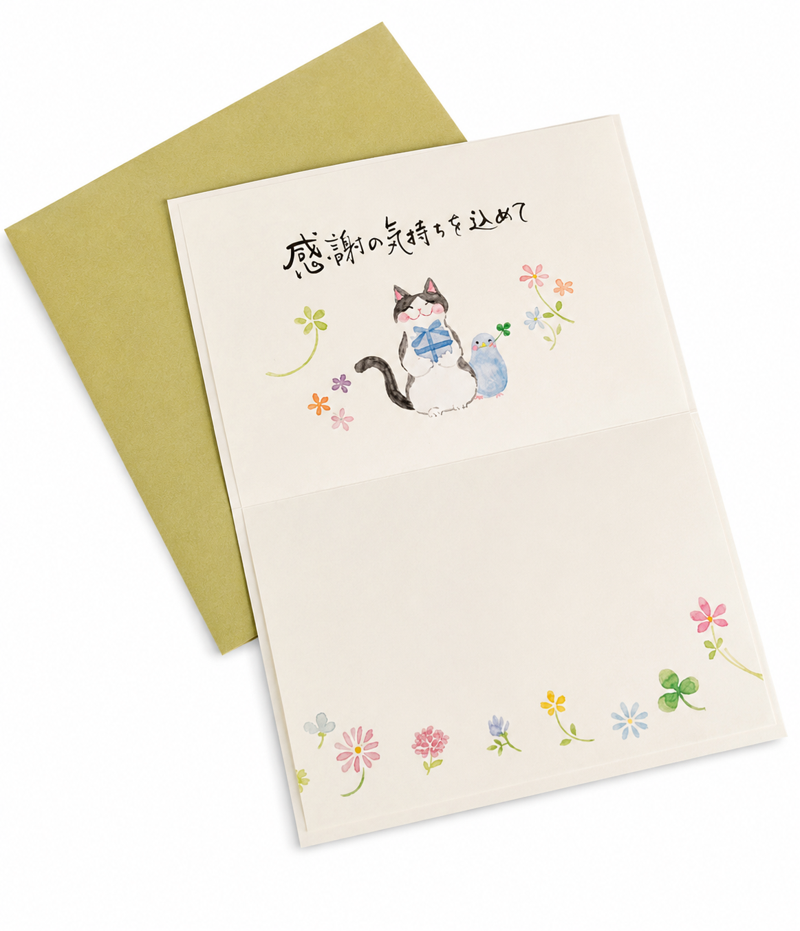 A folded greeting card with a watercolor illustration of a cat and Japanese text, shown with a muted green envelope on a white background.