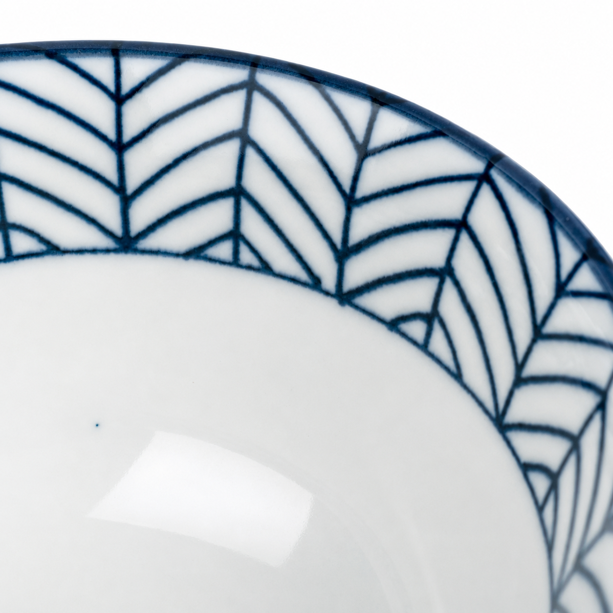Close-up of Yabane Geometric Japanese porcelain rice bowl showing fine indigo blue arrow feather pattern detail on white glaze