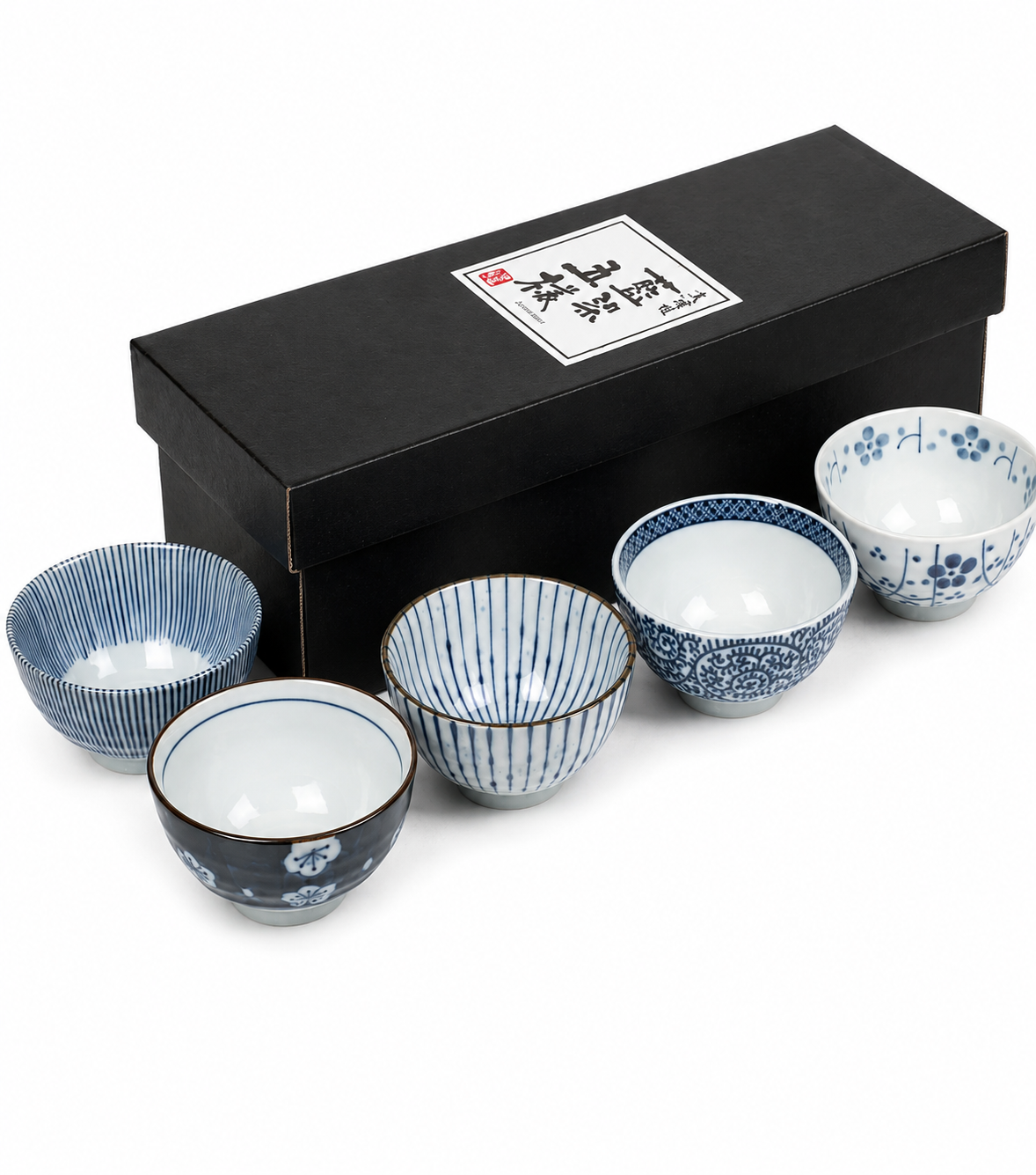 Three Japanese Aizome rice bowls showing interior and exterior detail — arabesque medallion, dark navy sakura, and fine stripe patterns
