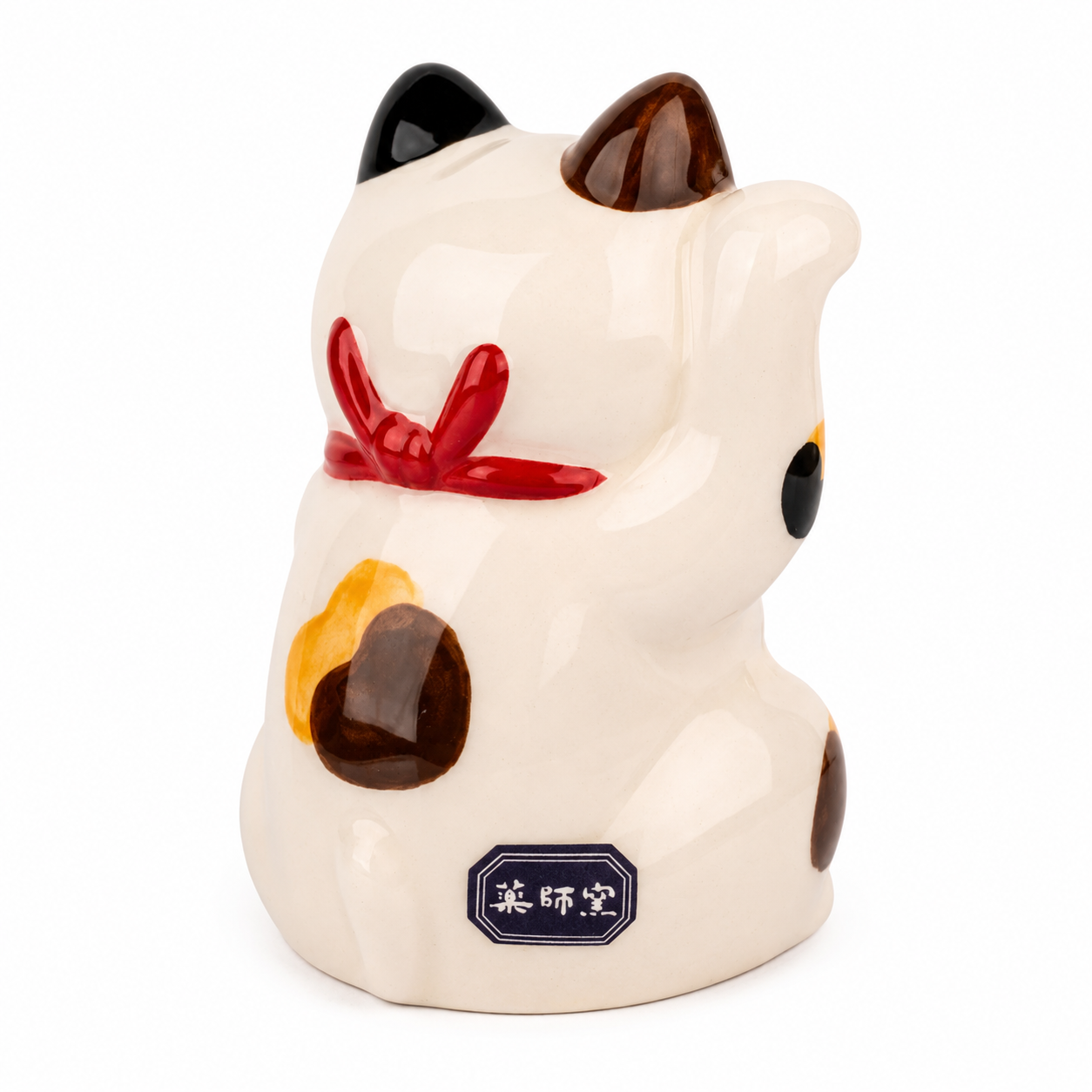 Calico Japanese Maneki Neko lucky cat with gold coin and red cushion, made in Japan.