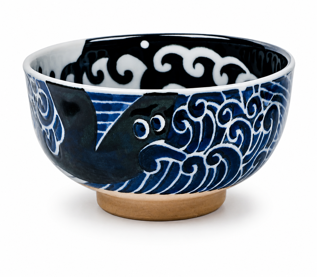 Whale Indigo Blue Japanese porcelain bowl with whale and wave design and terracotta-coloured foot.