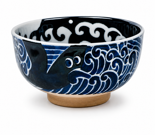 Whale Indigo Blue Japanese porcelain bowl with whale and wave design and terracotta-coloured foot.