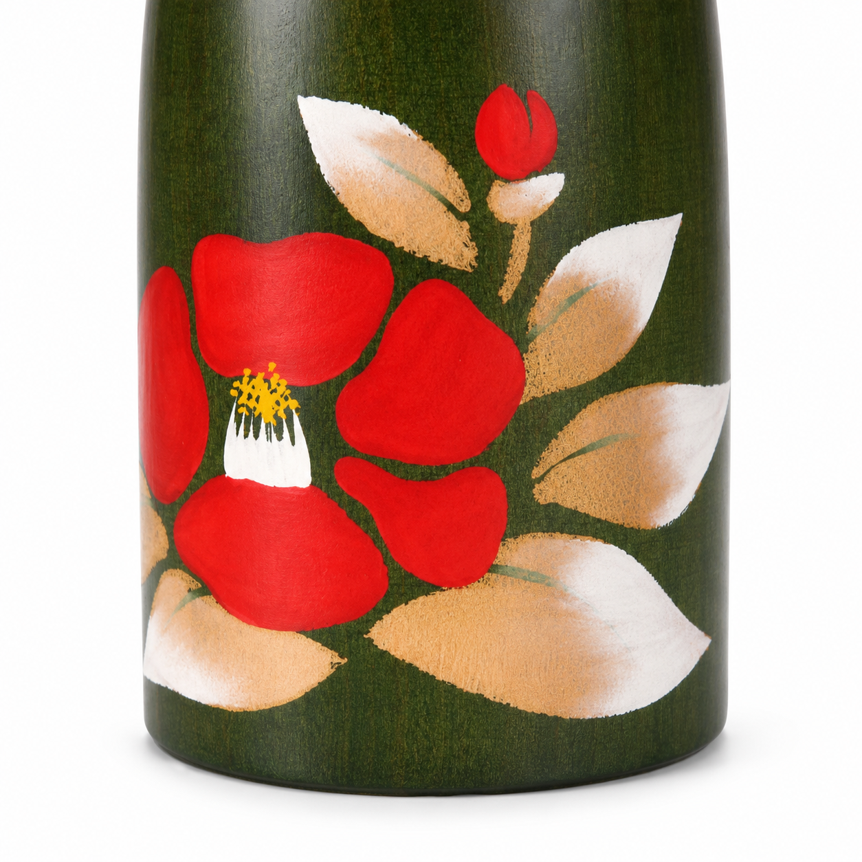     Close-up of the hand-painted red camellia flower and leaf details on the green wooden Kokeshi doll.