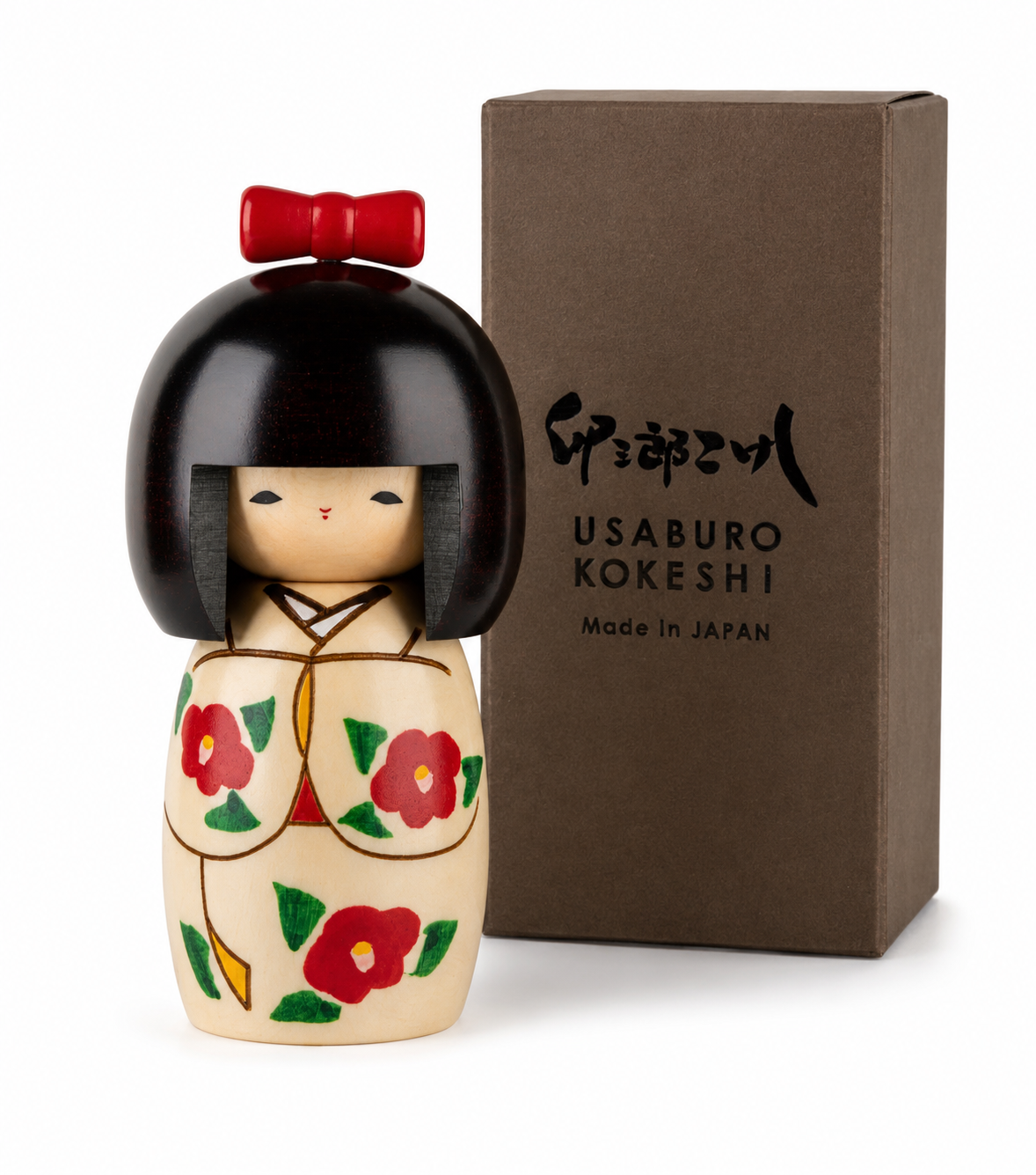     Side view of the handmade Japanese Kokeshi doll showing its natural wood body and floral decoration.