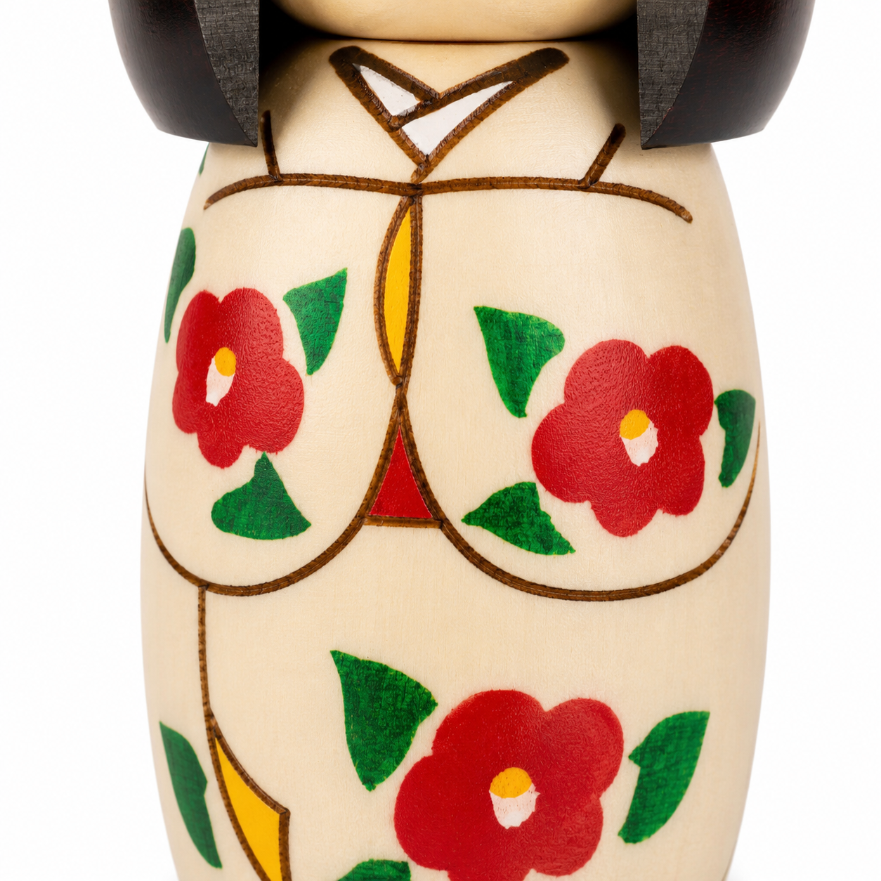     Close-up of the hand-painted red camellia flowers and kimono-style details on the natural wood Kokeshi doll.