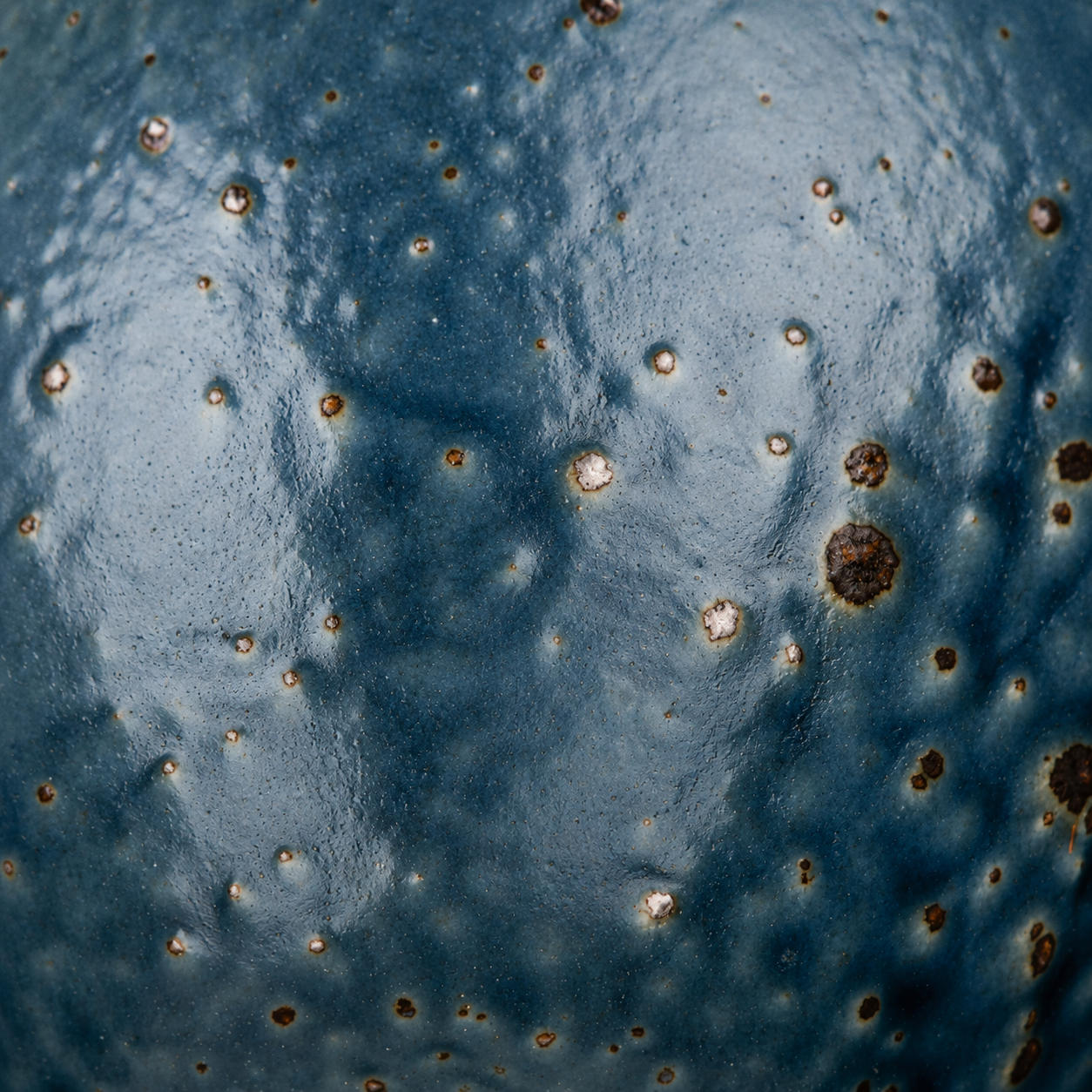 Close-up of Blue Wabi Sabi Japanese porcelain bowl glaze showing rustic speckled blue and brown wabi-sabi texture detail