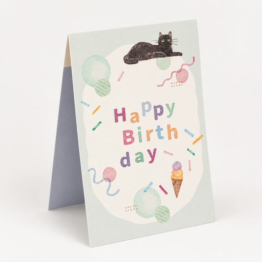 Black Cat Pop Open Mini Japanese Birthday Card front cover — relaxed black cat with pastel balloons, ice cream and confetti on a sage green background
