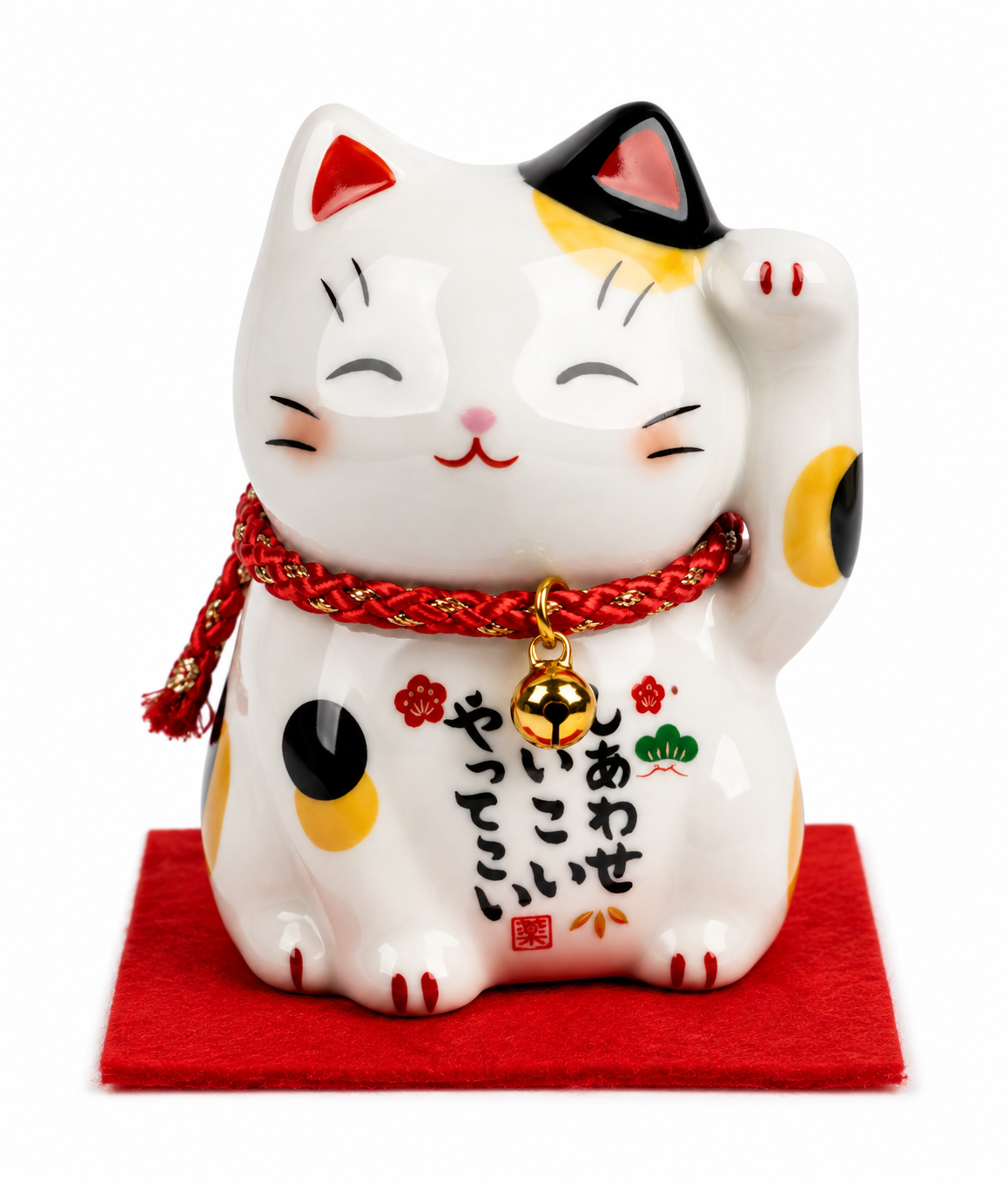 Calico Maneki Neko lucky cat figurine with right paw raised, red braided collar with gold bell, painted with Japanese kanji 'Shiawase Koi Koi Yatte Koi', seated on red felt mat