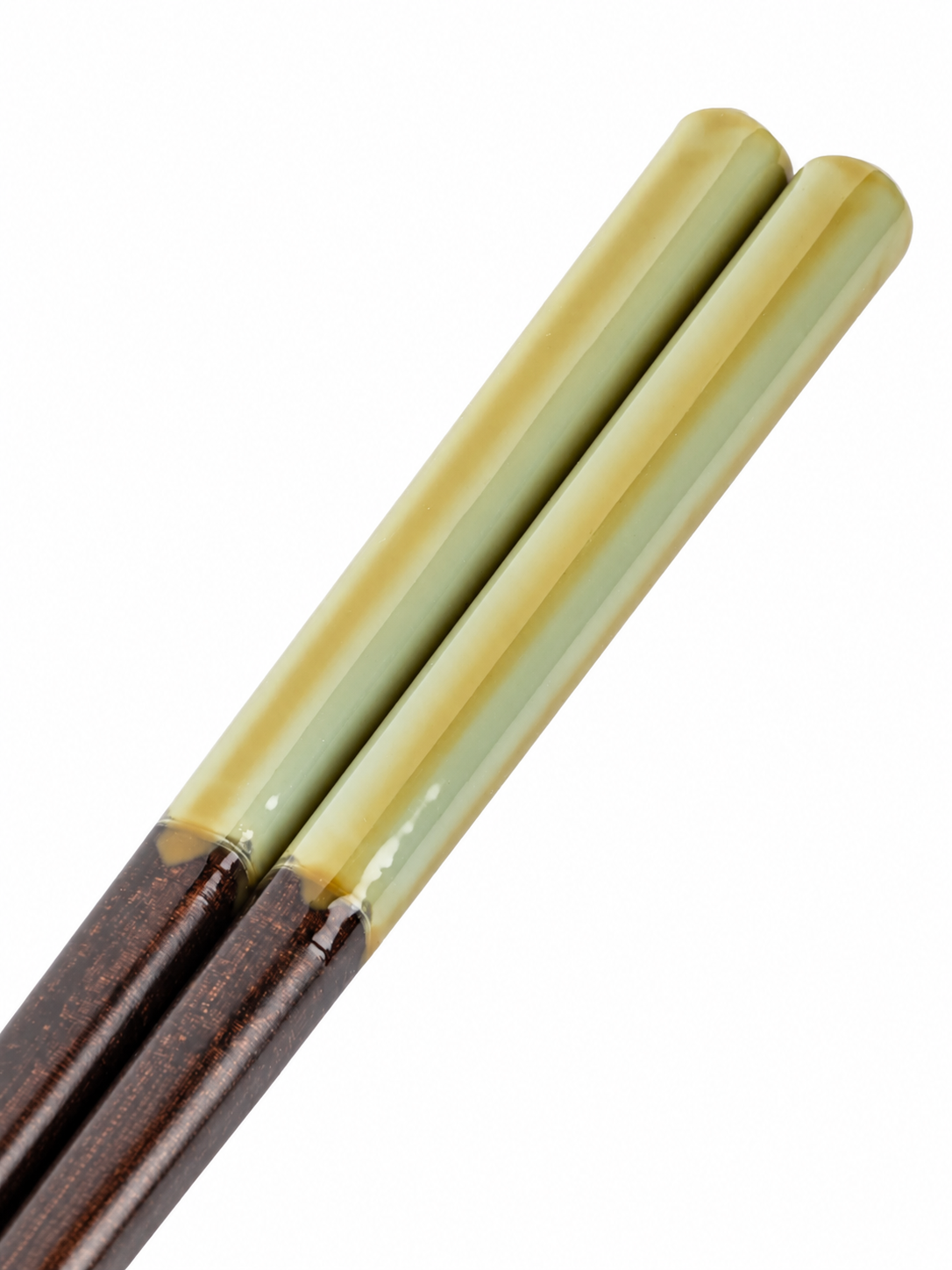 "Close-up of sage green and cream ombre handle tips of Japanese Torico chopsticks, showing smooth lacquer finish"
