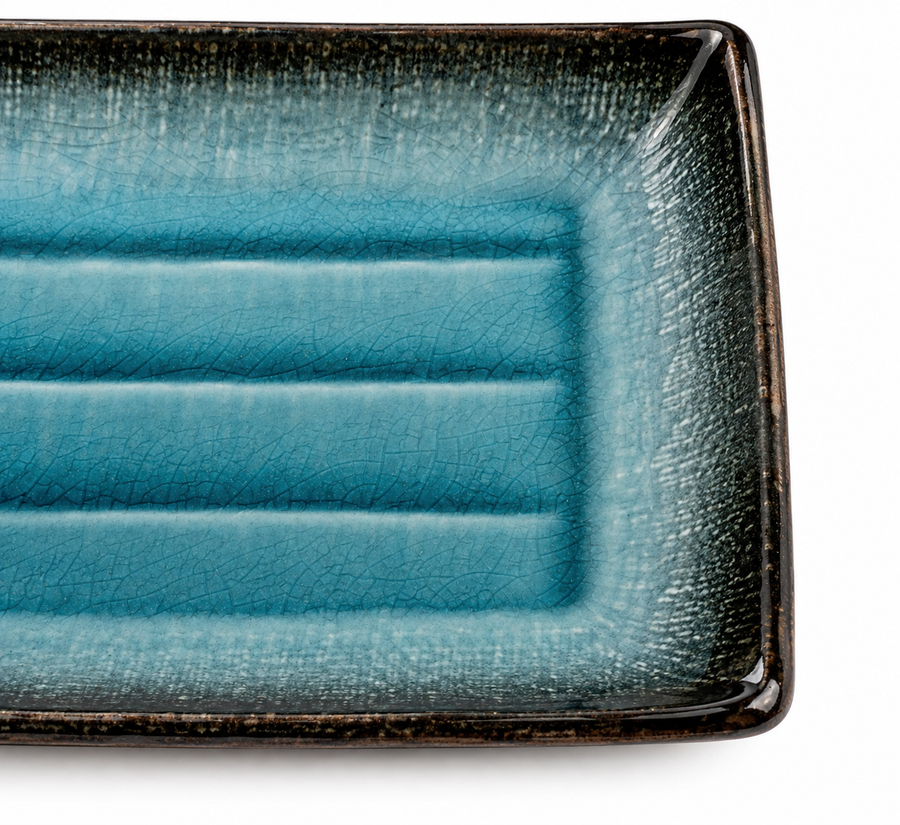 Close-up of sea blue crackle glaze ceramic sushi plate showing kannyū crackle pattern and dark rustic edges, made in Japan
