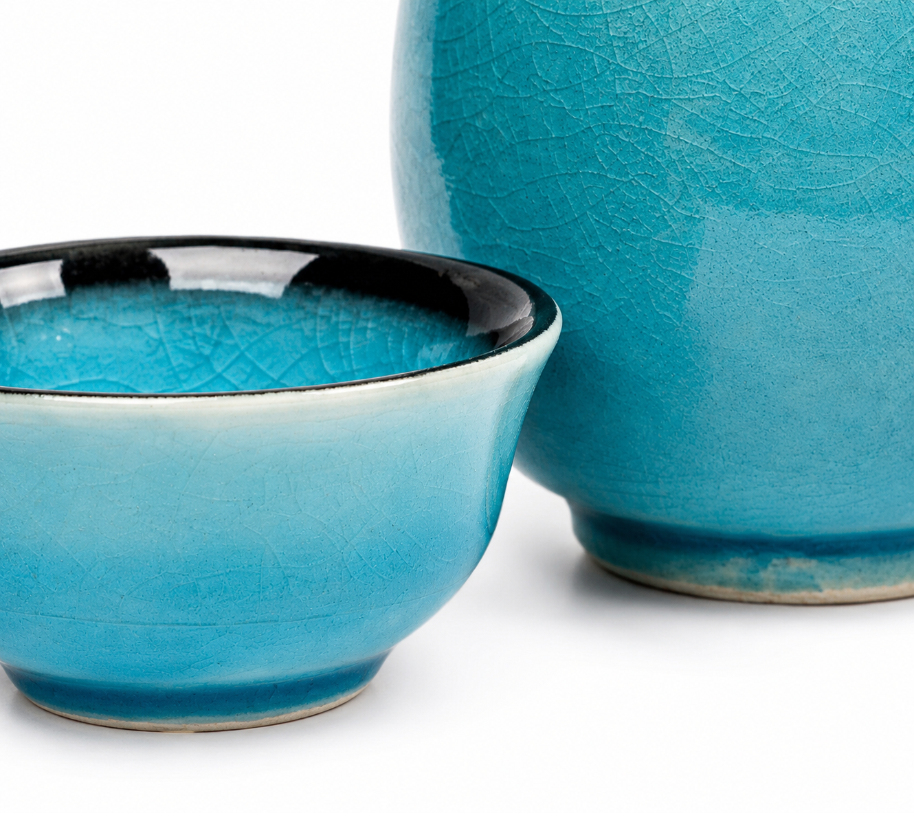 Close-up of Sea Blue Crackle Glaze sake cup and jug showing teal crackle glaze texture with black rim, ceramic, made in Japan