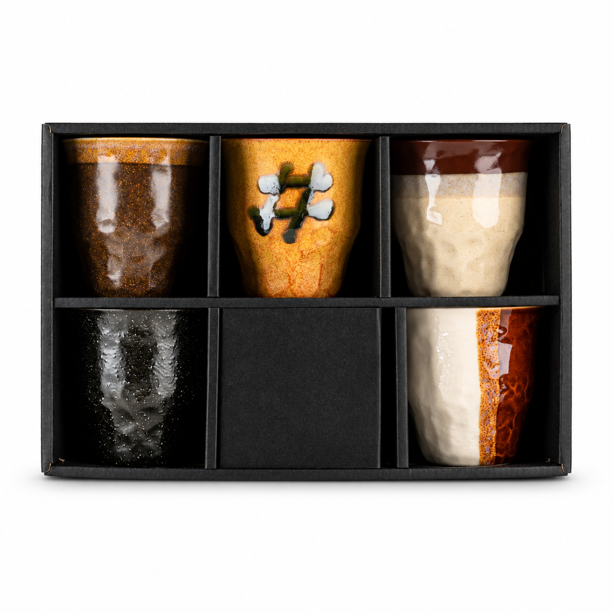 Five ceramic cups displayed in front of the set’s black gift box.
