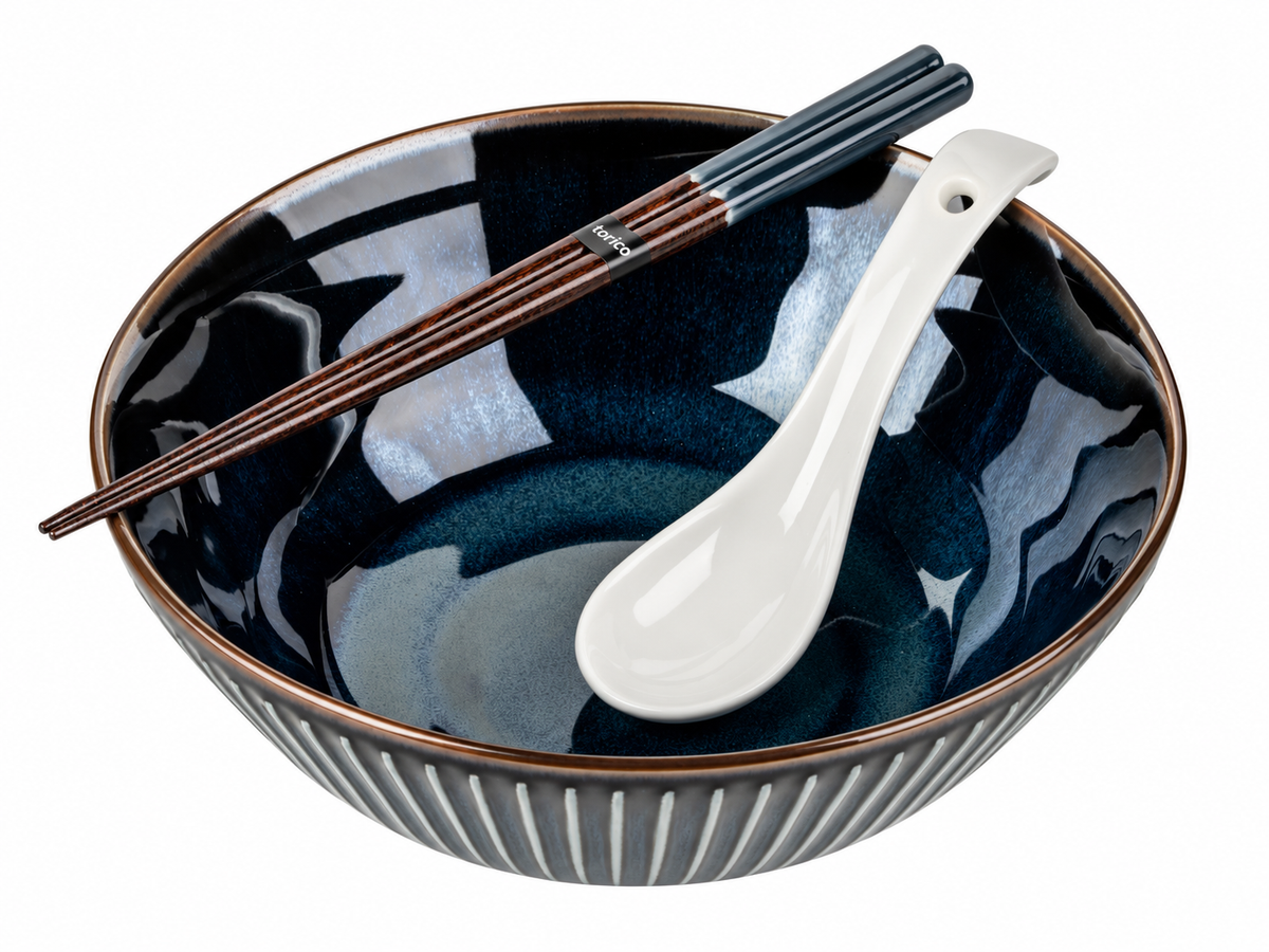 Navy Sendan ramen bowl, made in Japan, with a white soup spoon and wooden chopsticks resting across the rim.